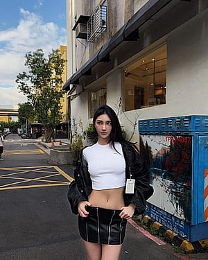 White crop top with black jacket and miniskirt'