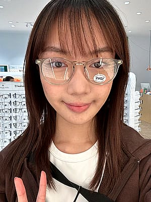 Filipina cutie trying on glasses'